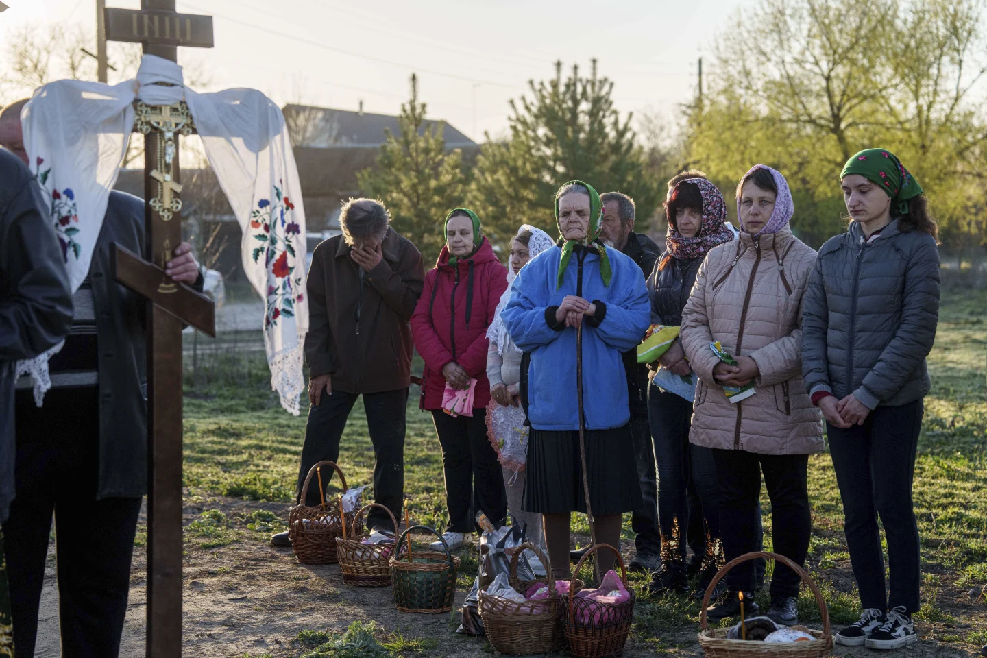 Люди стоять у черзі, щоб освятити пасхальні кошики під час святкування православної Пасхи в селі Красне, Україна, у неділю, 20 квітня 2025 року.